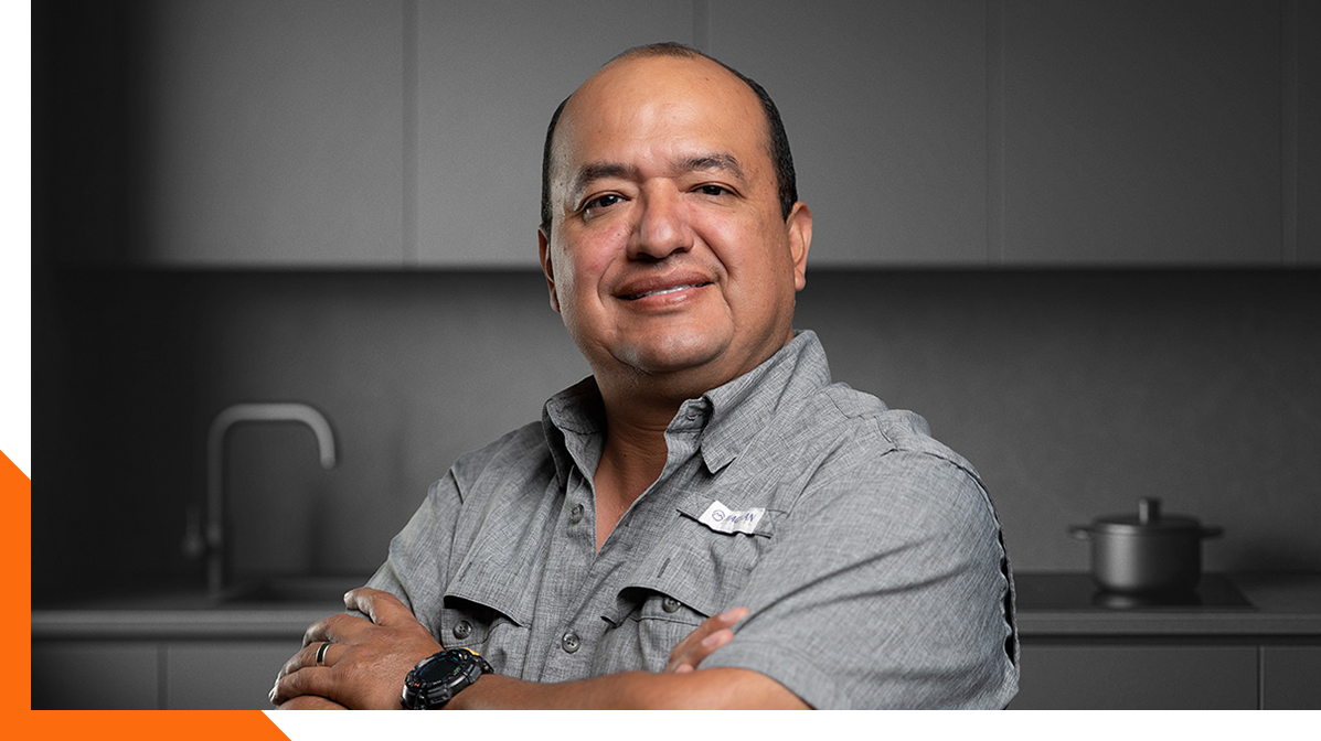 Omar Montano, Project Manager at L79 Properties, standing confidently in a modern kitchen remodel