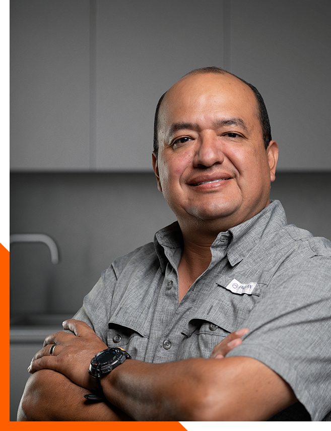 Omar Montano, Project Manager at L79 Properties, standing confidently in a modern kitchen remodel
